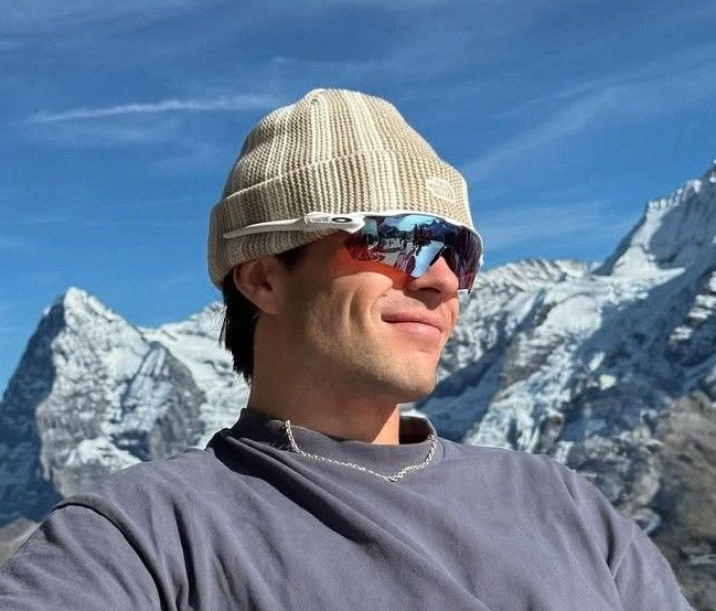 A knit beanie cuff stretched wide to test its recovery