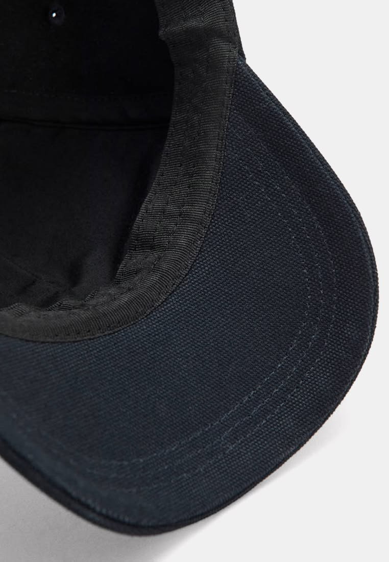 Cap brim showing its stiff core curve